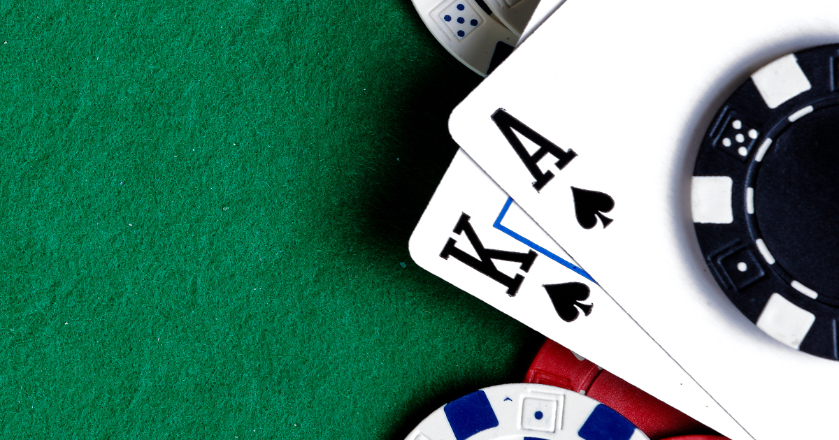 King and ace blackjack hand with chips at a casino rental table