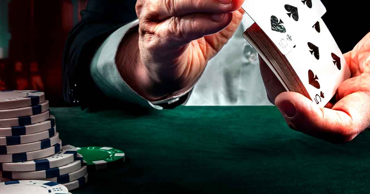 Casino dealer shuffling cards at a party rental table